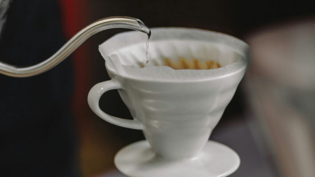 Pouring hot water over coffee grounds pour over method